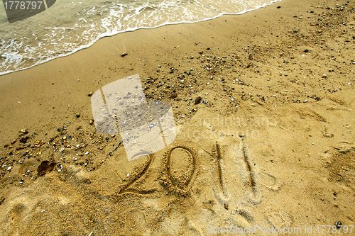 Image of 2011 on sand
