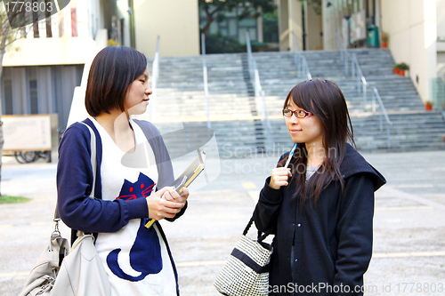 Image of Asian students studying and discussing in university