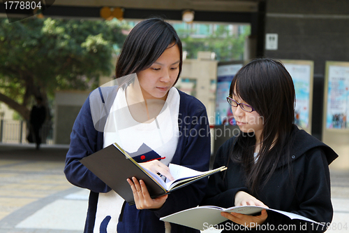 Image of Asian students studying and discussing in university