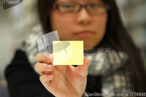 Image of Asian student with yellow memo paper