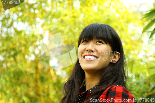 Image of Asian woman happy in nature