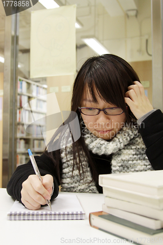 Image of Asian university student in library