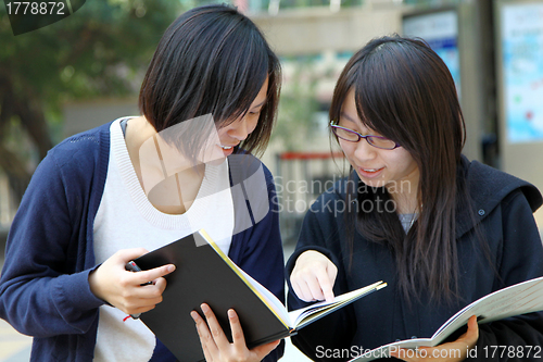 Image of Asian students studying and discussing in university