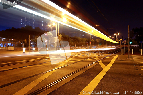 Image of Colorful light rail at night in city