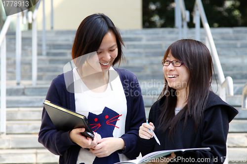 Image of Asian students studying and discussing in university