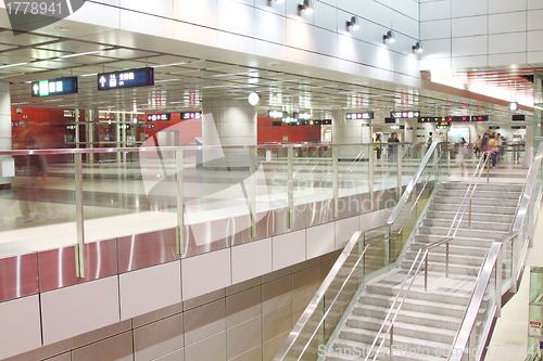 Image of Moving people in train station during rush hours