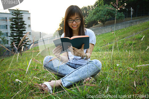 Image of Asian girl reading in university