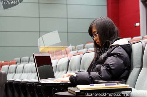 Image of Asian student using laptop to study