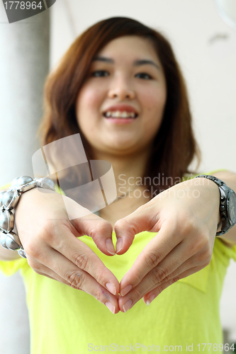 Image of Asian woman making a heart