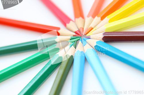 Image of Color pencils in arrange in color wheel colors on white backgrou