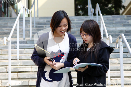 Image of Asian students studying and discussing in university