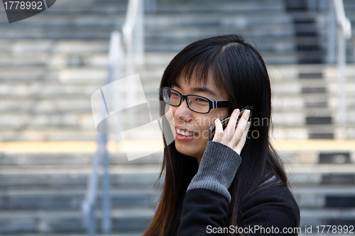 Image of Asian woman talking phone