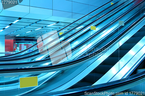 Image of Moving escalator in modern interior, motion blurred.