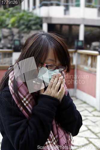 Image of Asian sick girl wearing mask