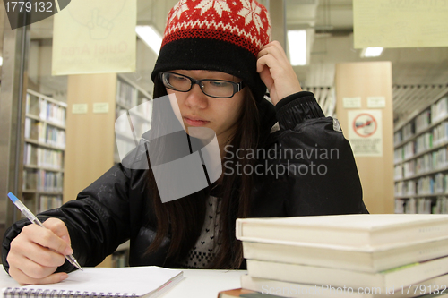 Image of Asian woman studying in library