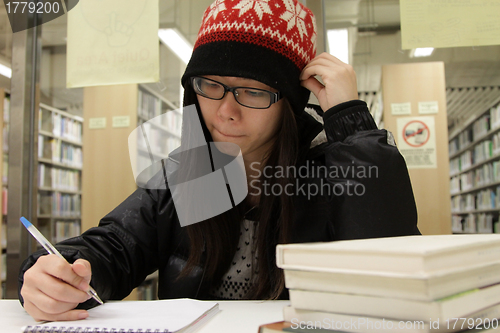 Image of Asian woman studying in library