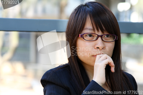 Image of Businesswoman thinking outdoor