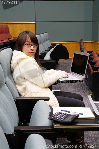 Image of Asian university student using laptop and studying