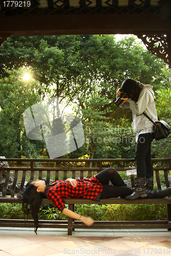 Image of Asian woman taking photos, model and photographer.