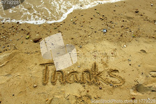 Image of Thanks words on sand