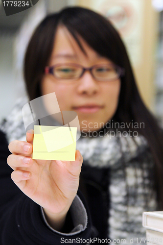 Image of Asian student with yellow memo paper