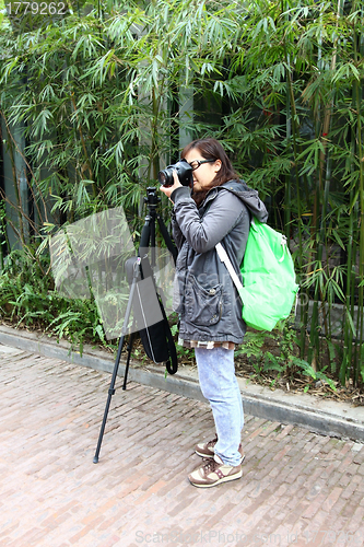 Image of Female photographer with tripod