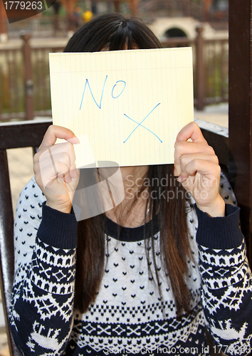 Image of Woman holding NO signage