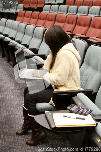 Image of Asian student using laptop to study