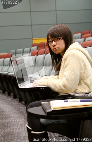 Image of Asian student using laptop to study