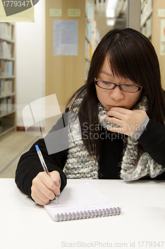 Image of Asian woman studying in library