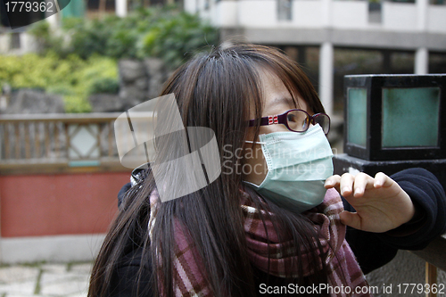 Image of Asian sick girl wearing mask