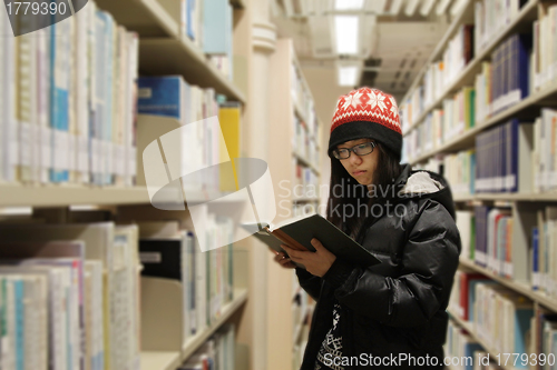 Image of Asian woman studying in library