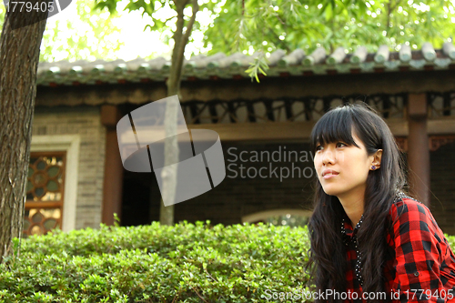 Image of Chinese girl thinking outdoor