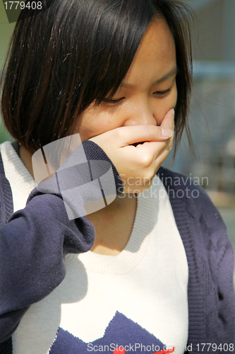 Image of Asian woman sneezing