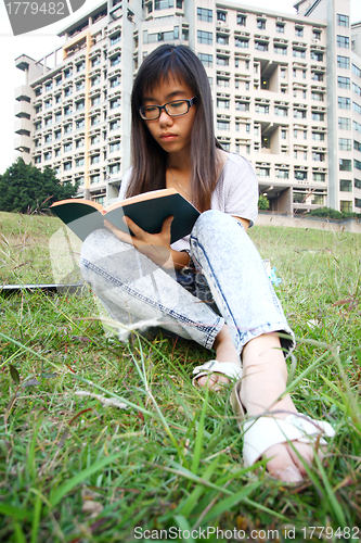 Image of Asian girl reading in university