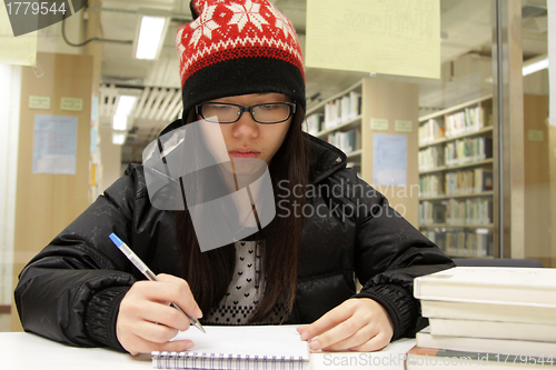 Image of Asian woman studying in library