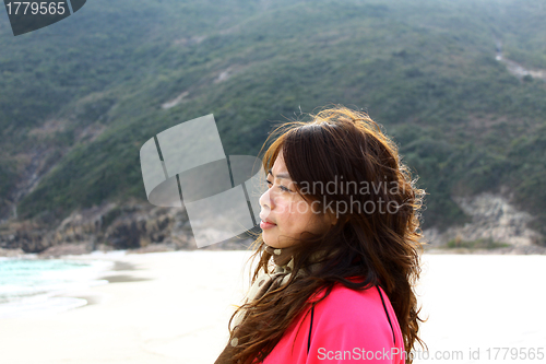 Image of Asian woman thinking on the beach