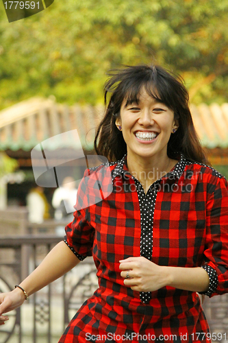 Image of Asian woman running with smile