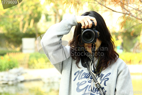 Image of Asian woman photographer