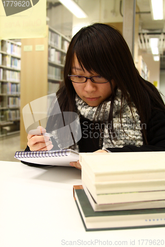 Image of Asian woman studying hard in a university