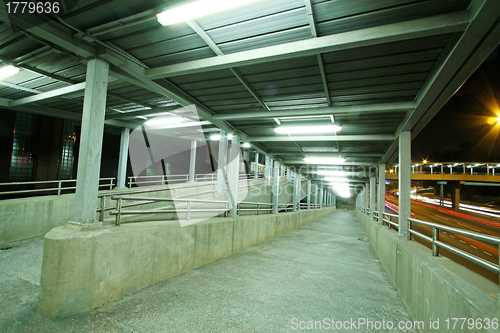 Image of Footbridge at night with moving cars