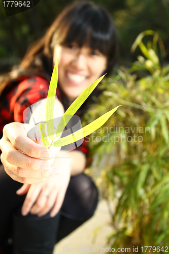 Image of Asian woman smiling under sunshine