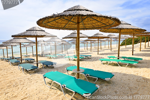 Image of Beach umbrellas on sandy seashore