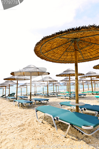 Image of Beach umbrellas on sandy seashore