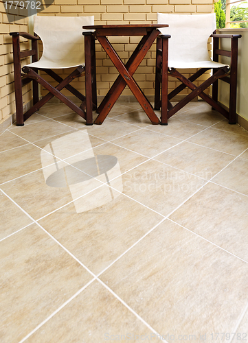 Image of Chairs and table on tiled floor