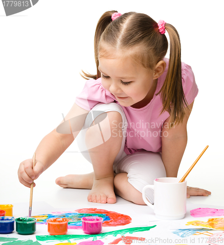 Image of Cute cheerful child play with paints