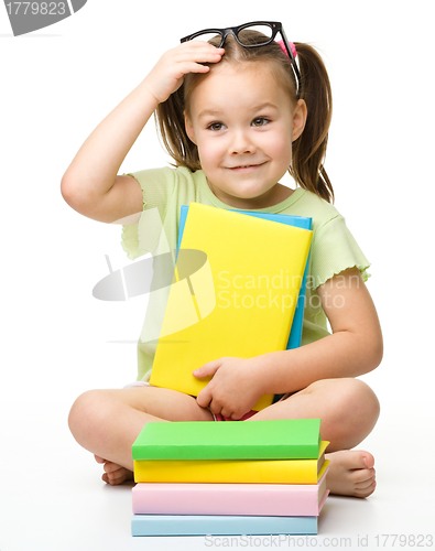Image of Cute little girl with books