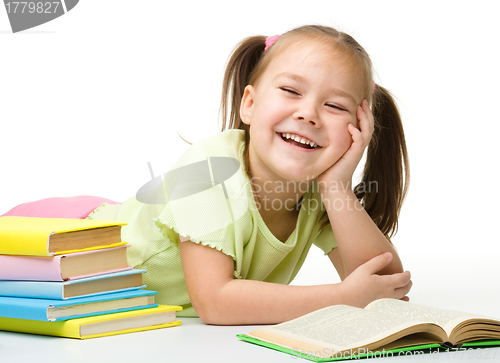 Image of Cute little girl reads a book