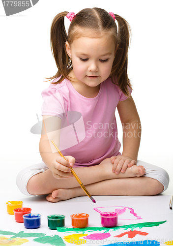 Image of Cute cheerful child play with paints