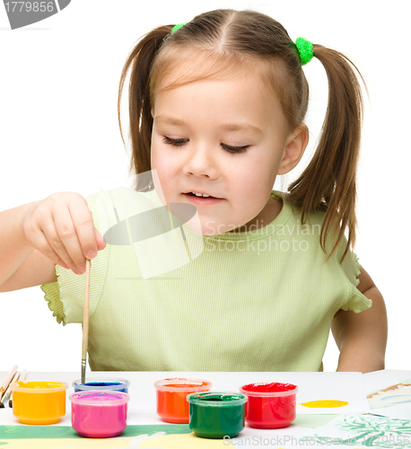 Image of Cute cheerful child play with paints